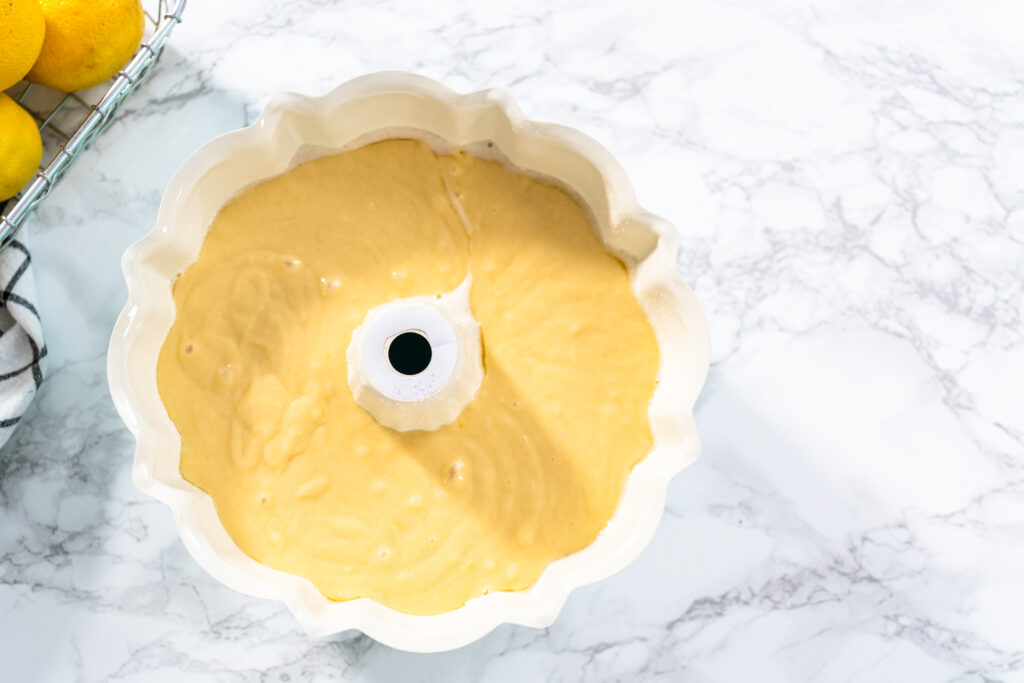 Lemon pound cake batter in a baking bundt pan ready to be baked.